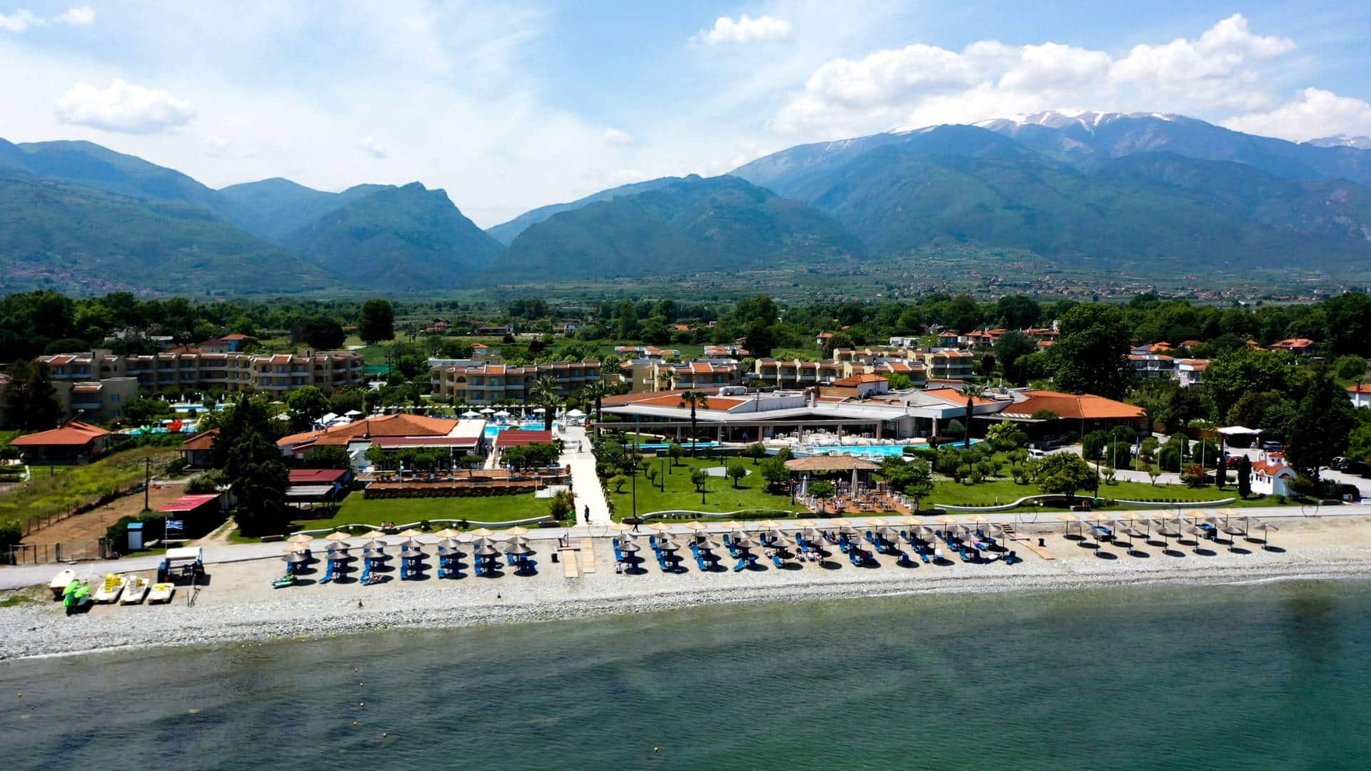 A panoramic view of North Greece, showcasing lush mountains, clear beaches, and cultural landmarks, representing the untouched beauty of the region.